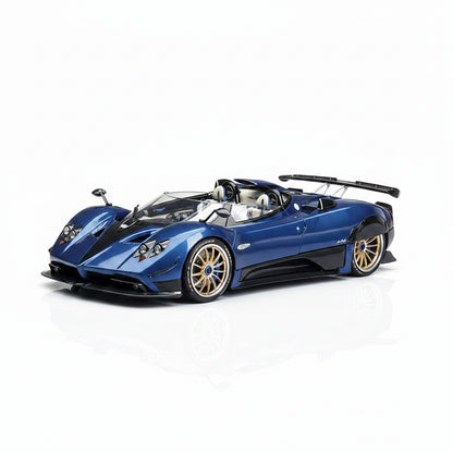Blue sports car with gold wheels on a gray textured background